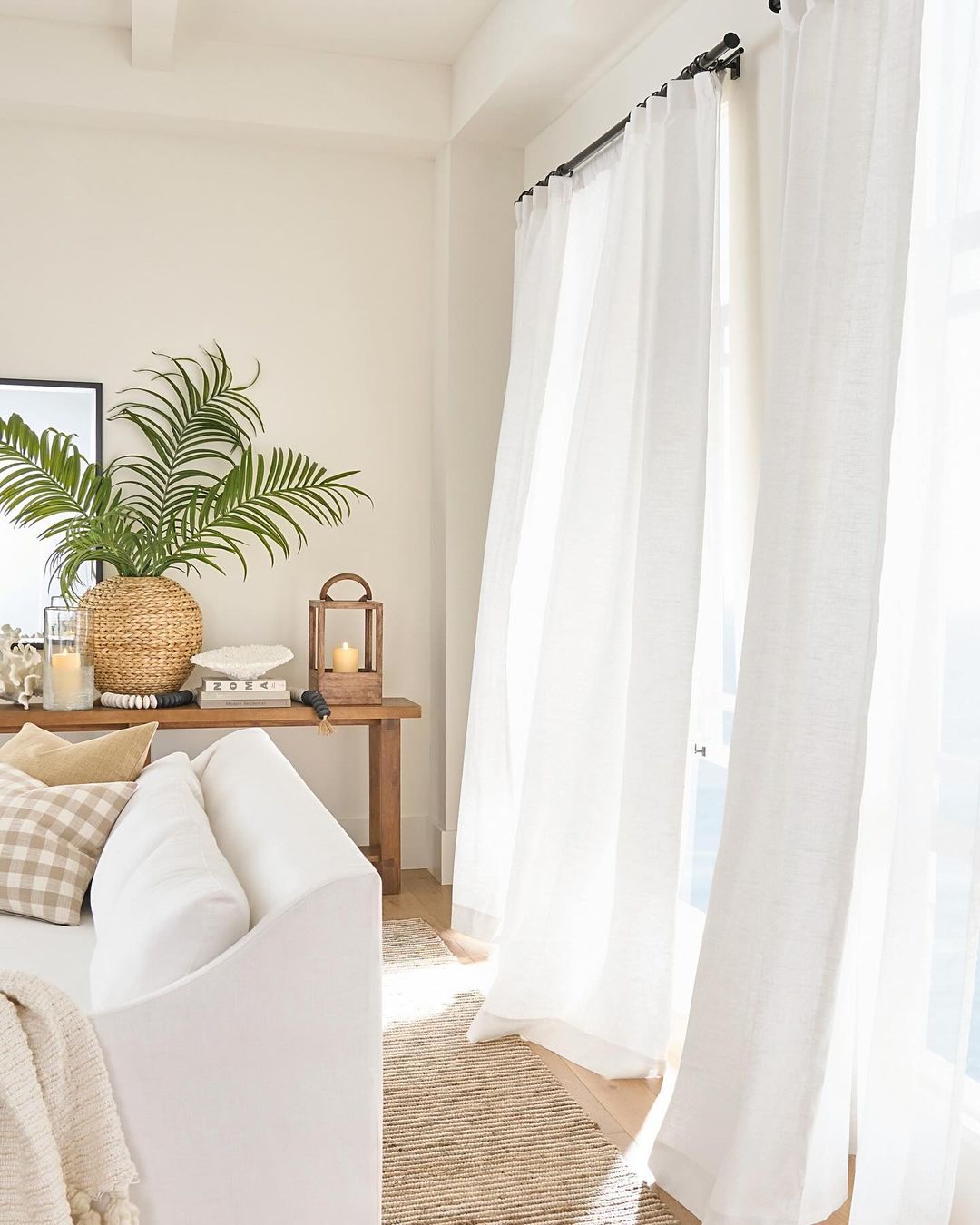 Cozy and well-lit living room corner with sheer curtains