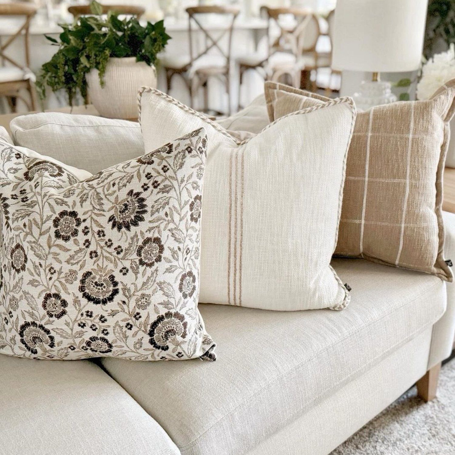 A neatly arranged living room setting with complementary throw pillows