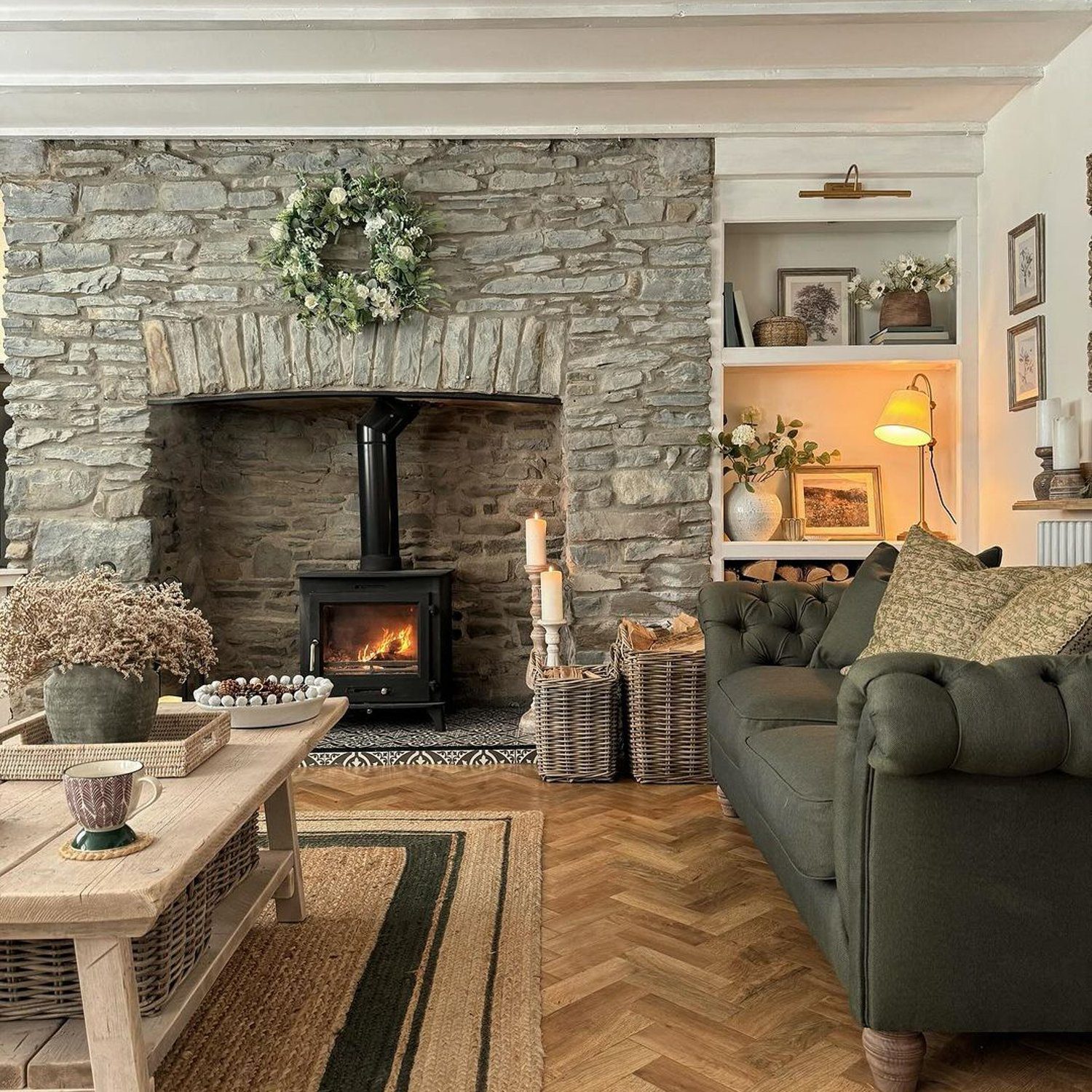 Cozy living room with a stone fireplace and warm decor