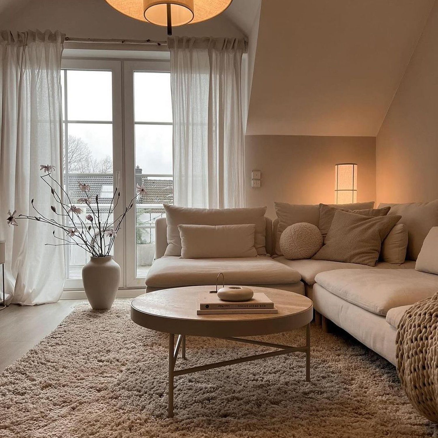 A warm and inviting living room with a comfortable couch, soft lighting, and minimalist decor