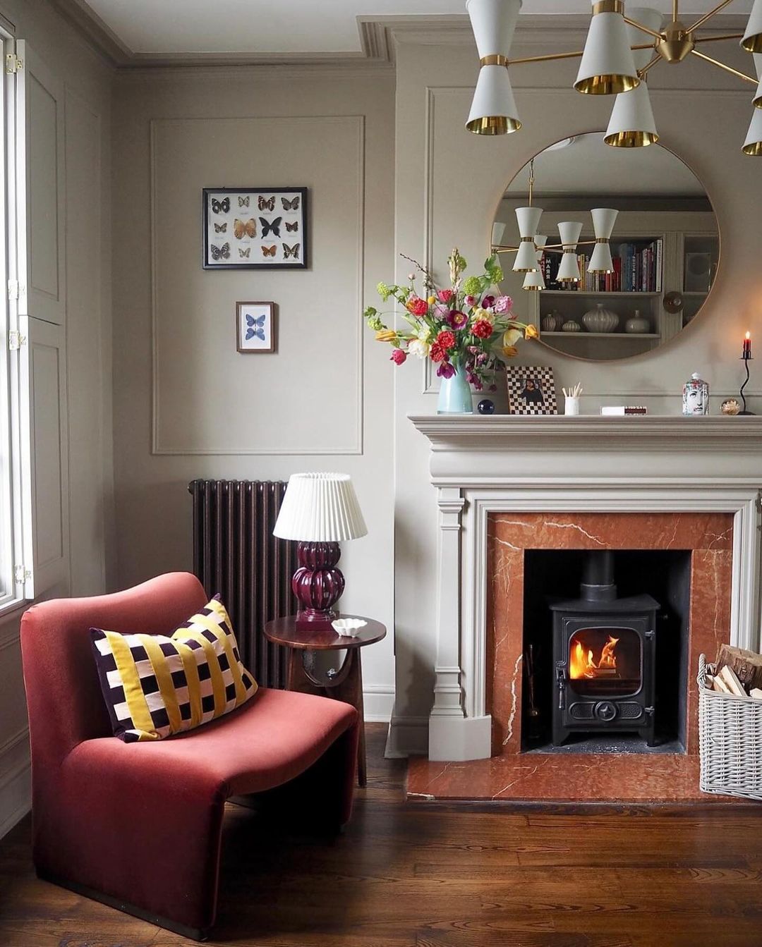 A cozy and stylish living room featuring a warm fireplace