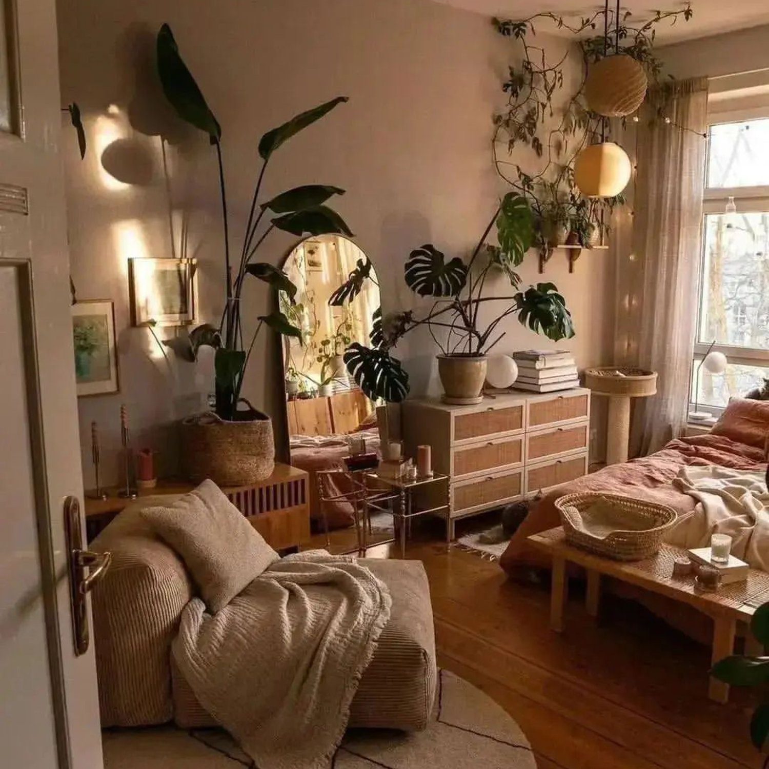 A cozy and warm-toned living room filled with lush green plants, and a comfortable seating area.