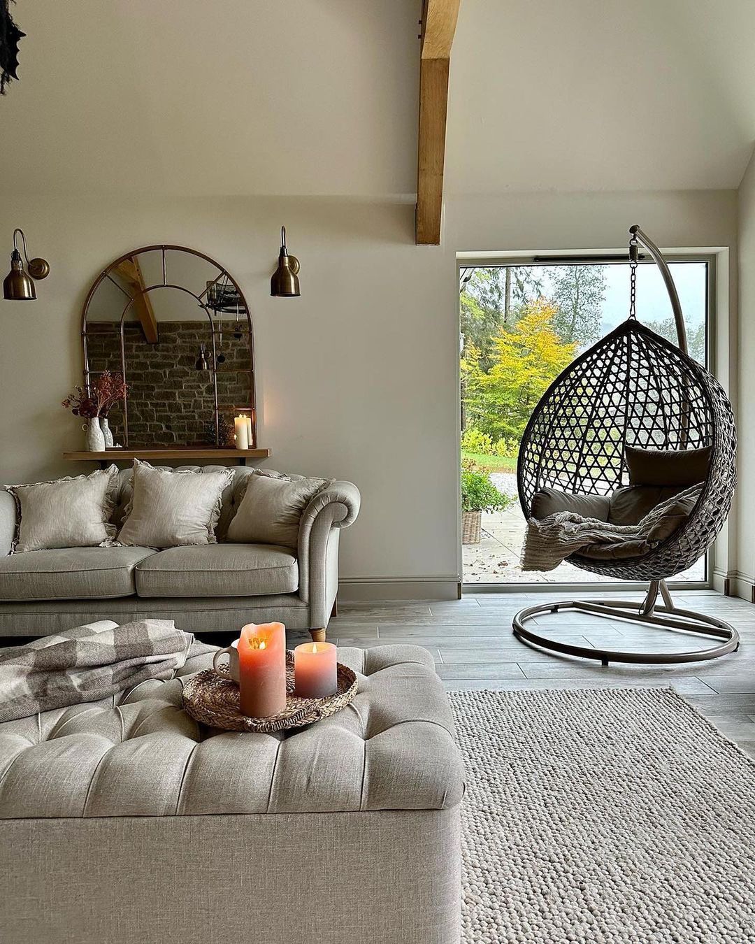 A cozy and inviting living room featuring a hanging egg chair