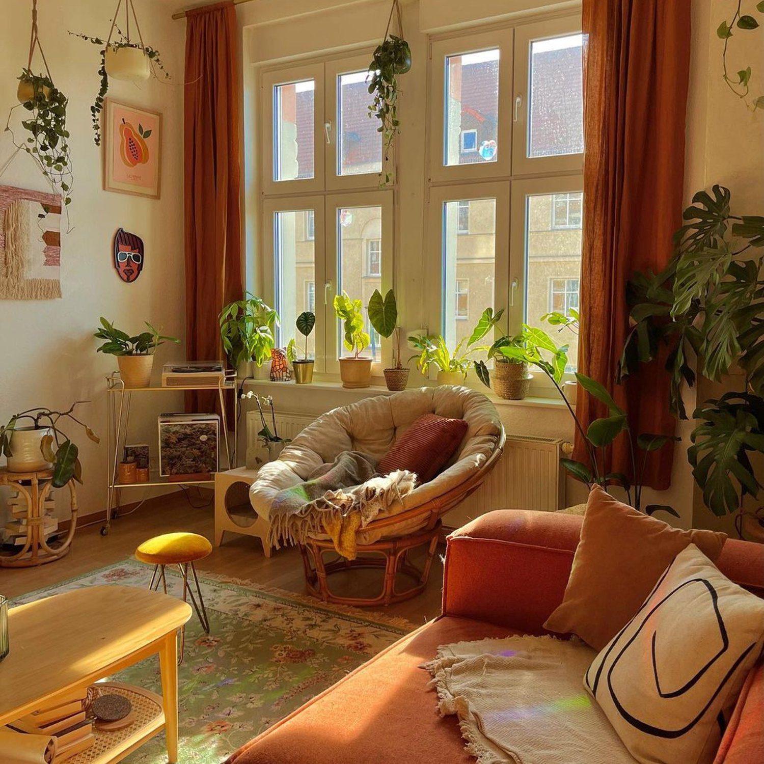 A cozy, well-lit living room with plants and warm colors