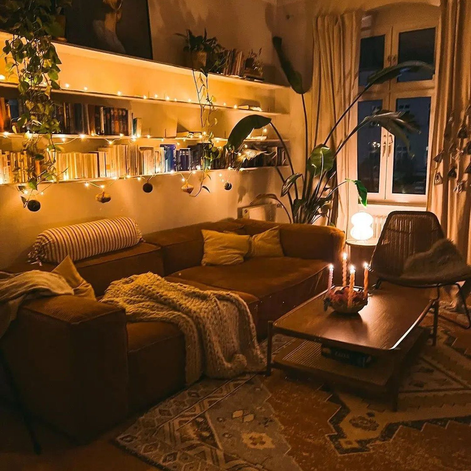 Cozy living room with warm lighting and lots of plants