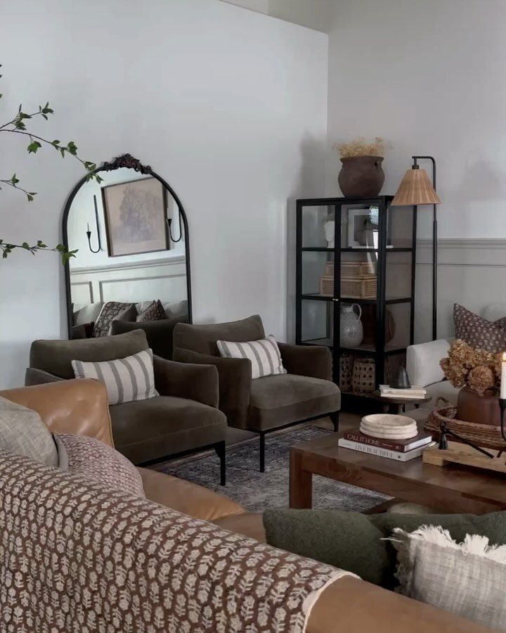 A tastefully arranged living room with a mix of textures and earthy tones.