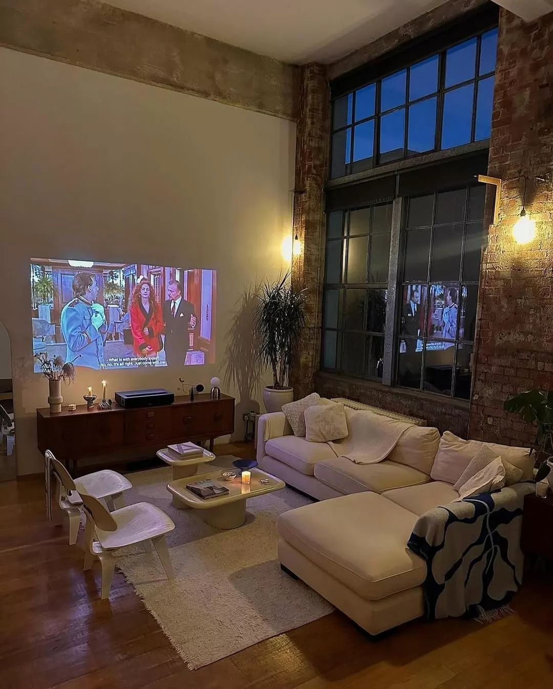 Cozy loft-style living room with exposed brick and projector screen