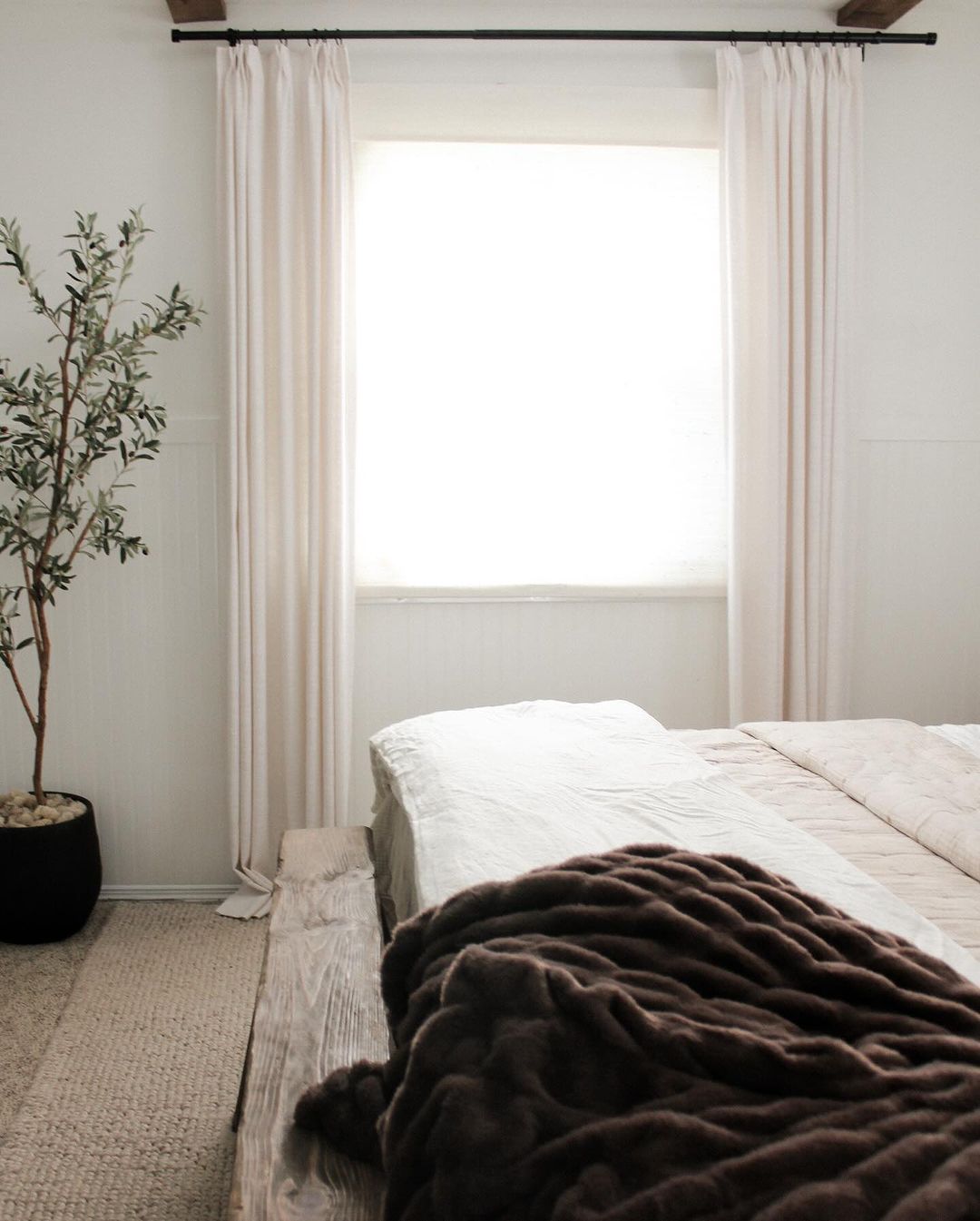 A minimalist bedroom with ample natural light