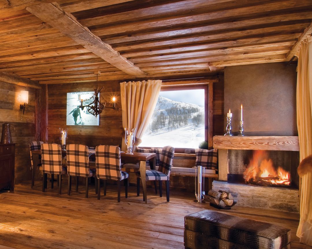 Cozy mountain cabin interior with a warm fireplace.