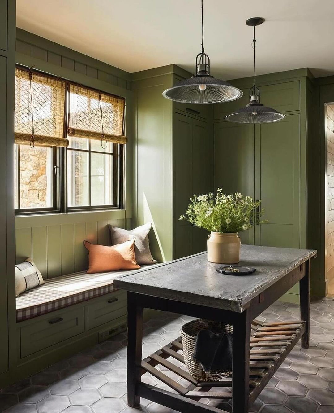 Cozy and stylish mudroom interior with olive green paneling