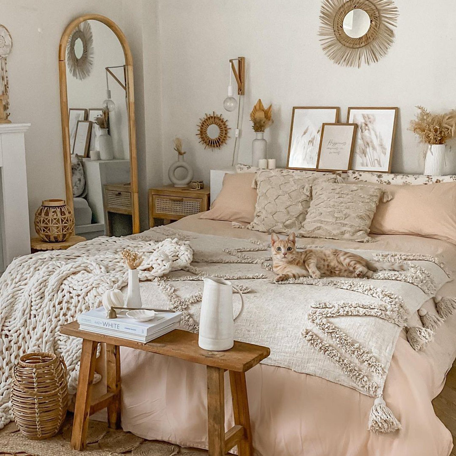 A serene bedroom with warm neutral tones and a lounging cat