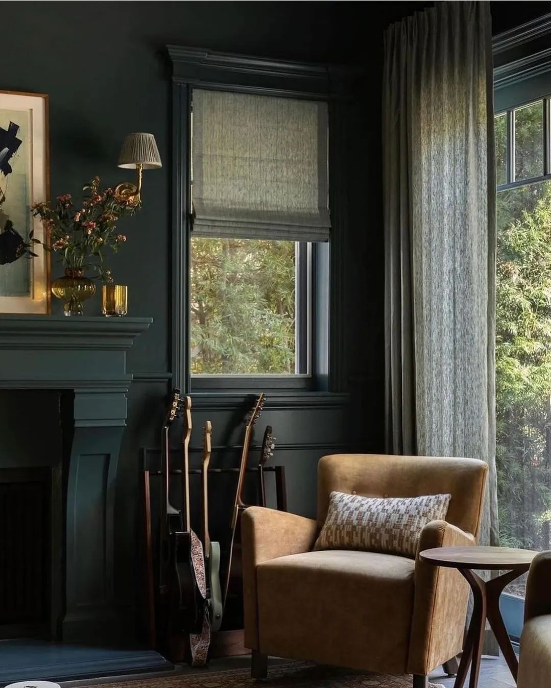 A cozy reading nook with dark walls and comfortable seating