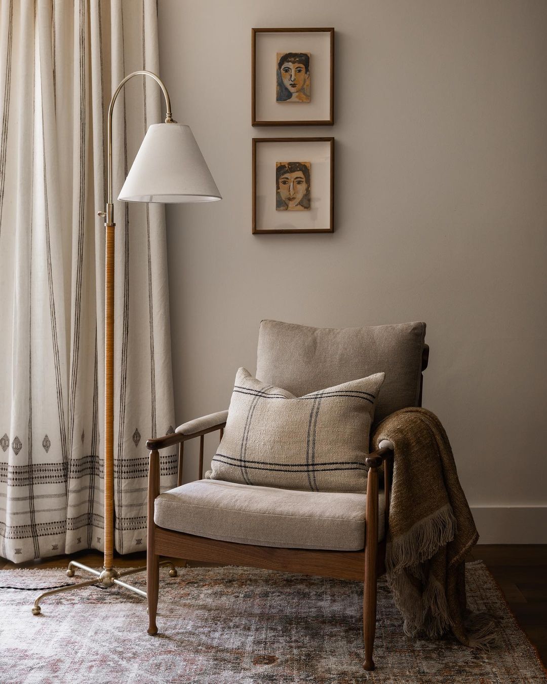 A cozy reading nook featuring a mid-century modern armchair