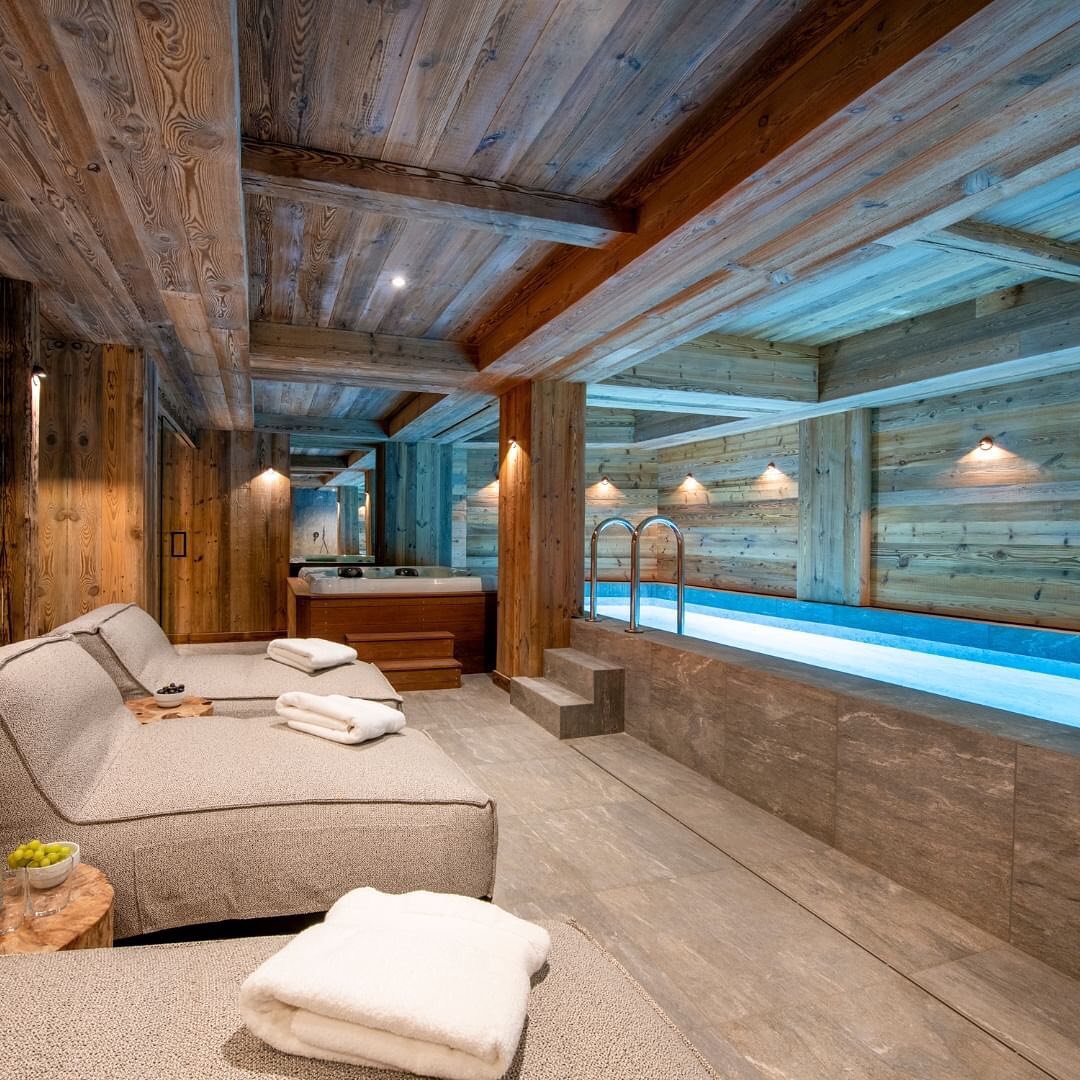 A cozy spa area with wooden interiors and a pool