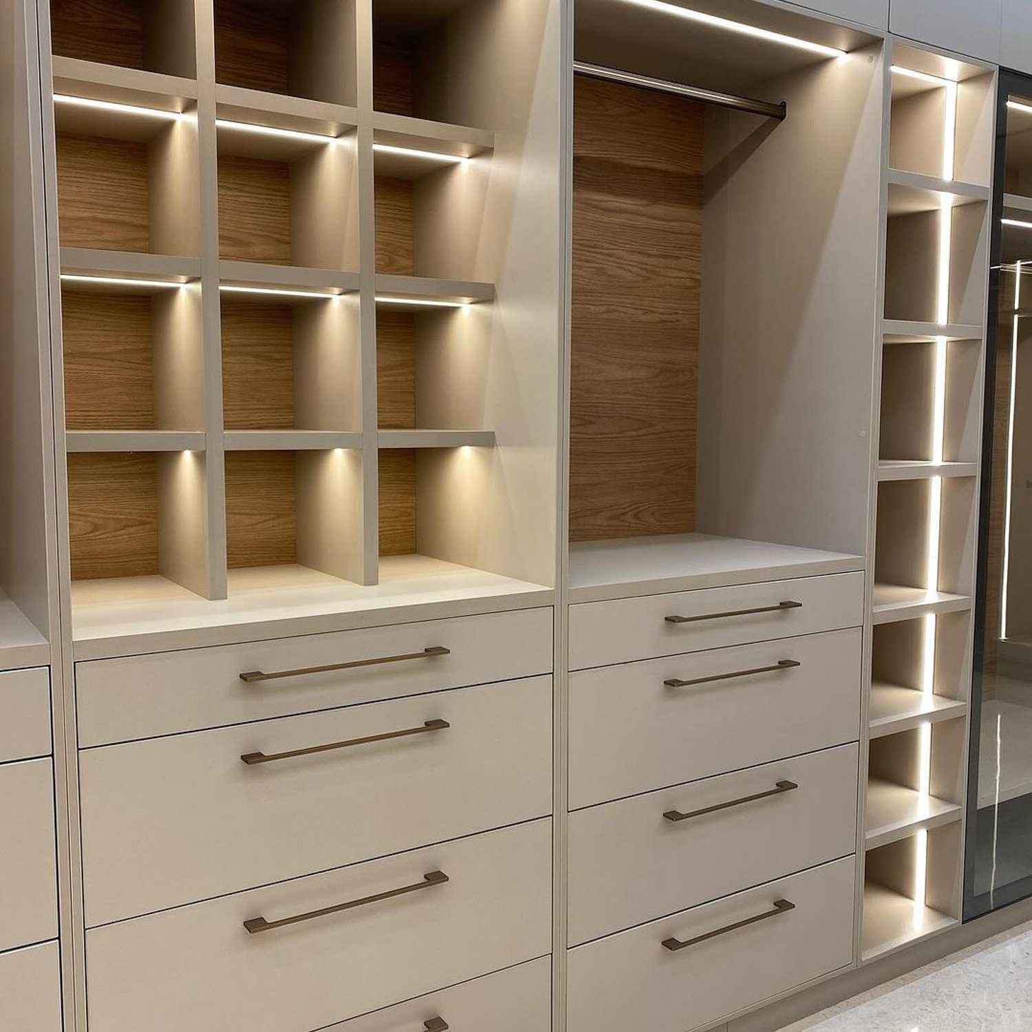 A modern and efficient closet design featuring bright LED lighting