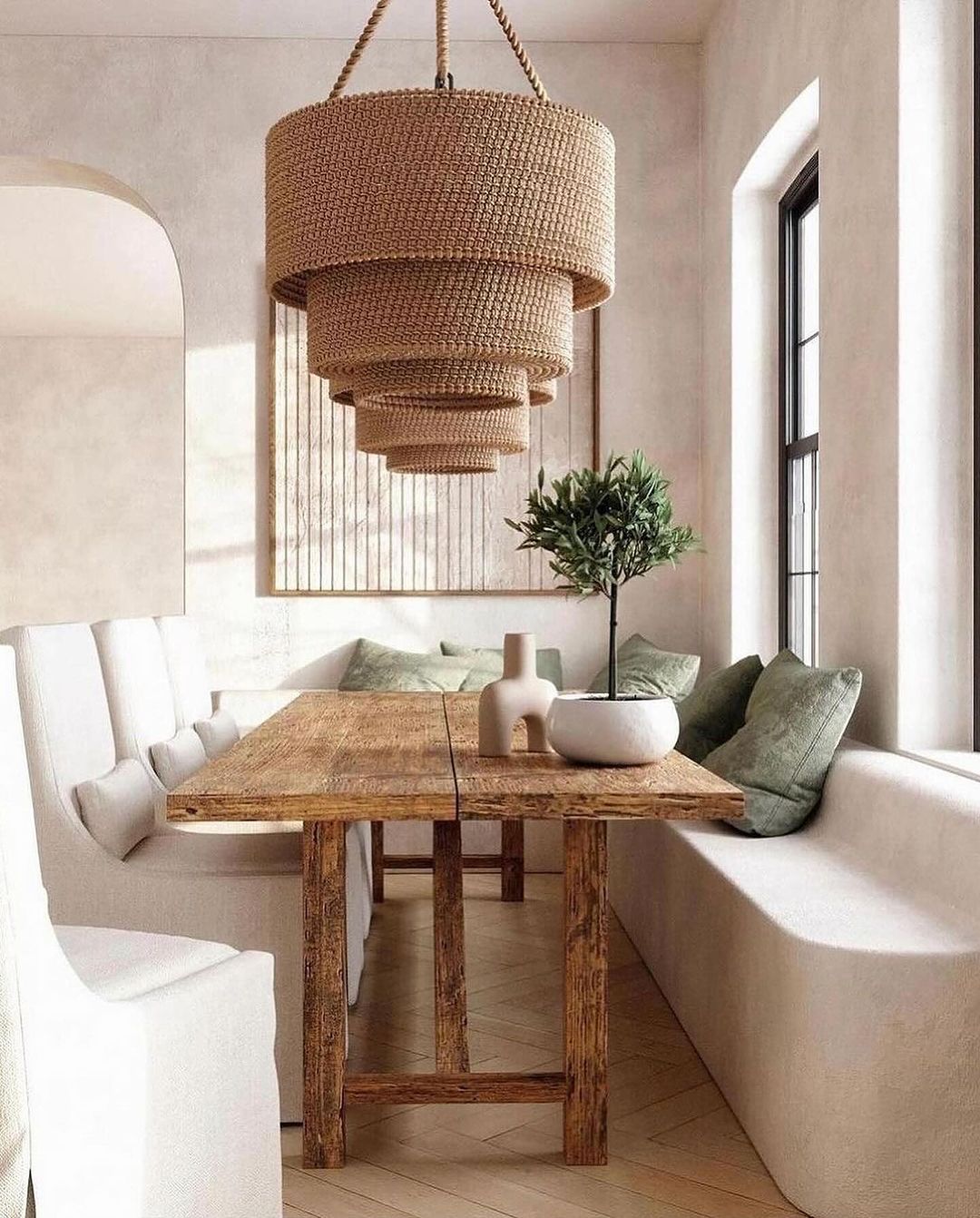 A serene dining space with a rustic wooden table and a large woven pendant light