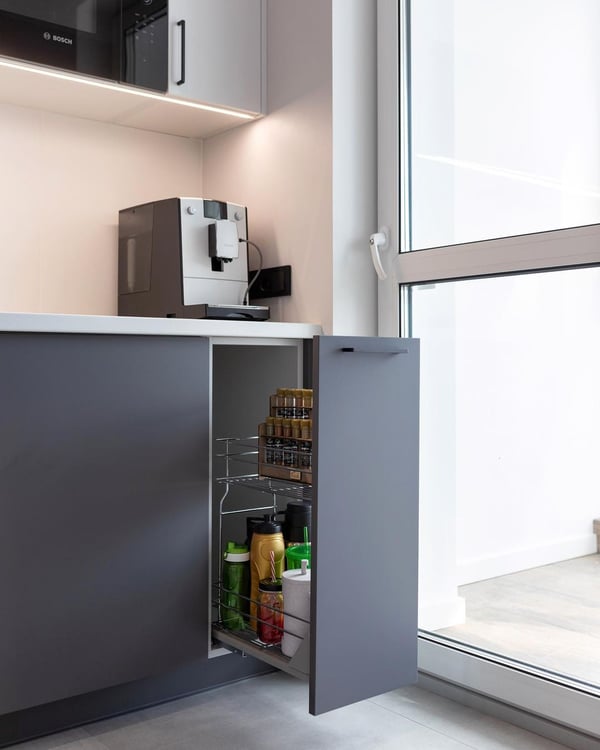 A sleek modern kitchen corner with an efficient pull-out pantry cabinet