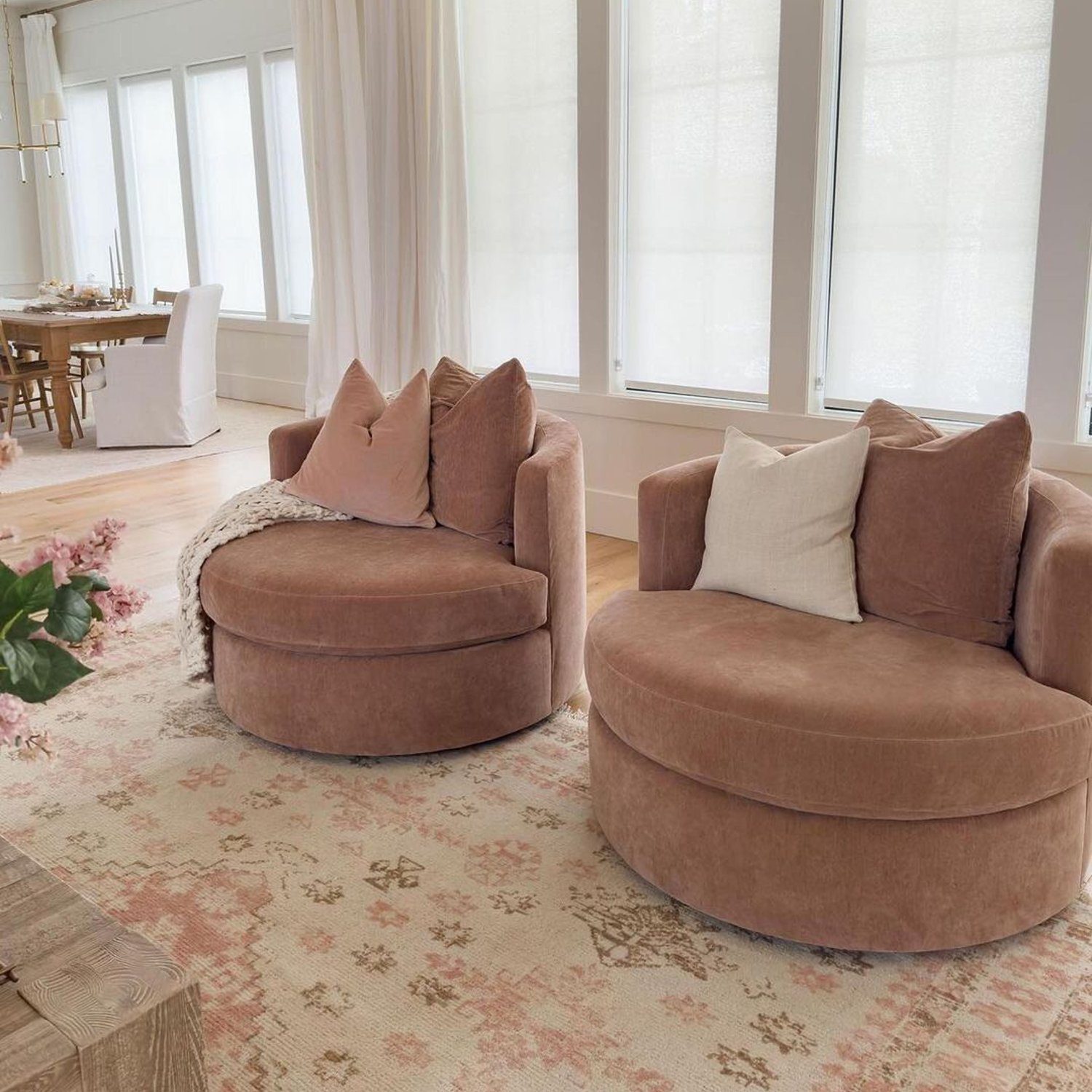 A serene living room setting with plush, round velvet sofas