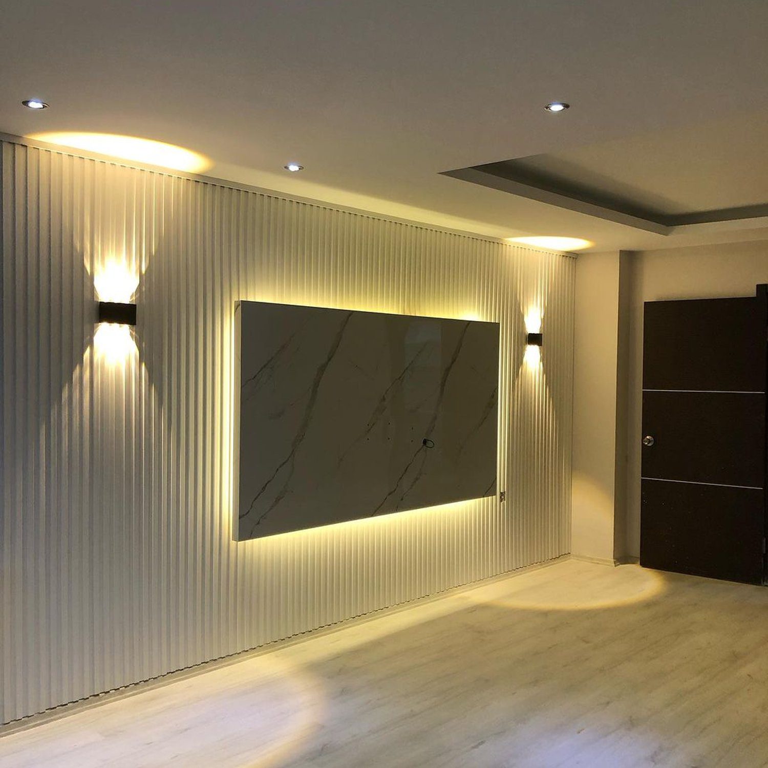 Elegant wall design featuring recessed lighting and structured wall paneling