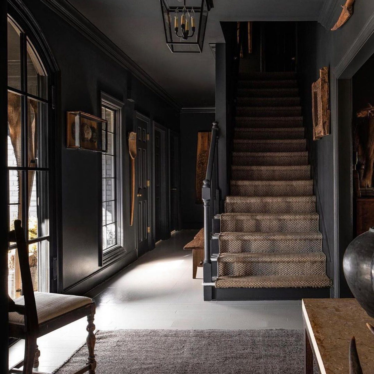 Moody and elegant foyer with dark walls and vintage decor