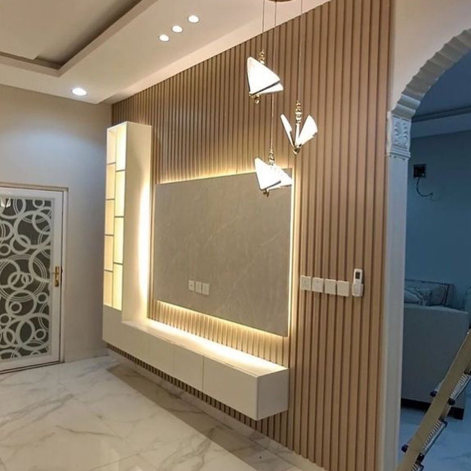 Elegant and modern foyer design featuring vertical ribbed wall paneling and warm lighting