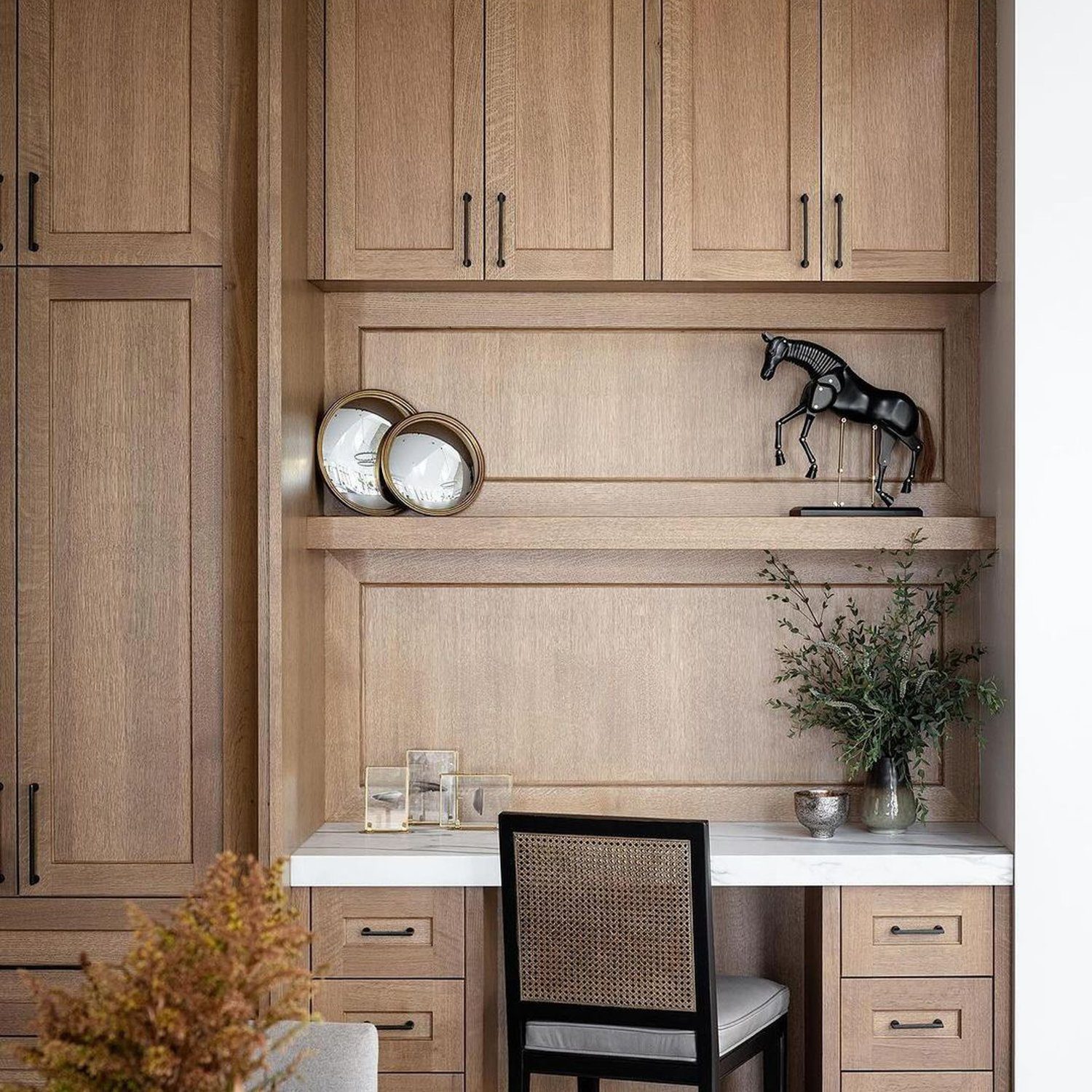 Elegant home office nook with wooden cabinets and décor