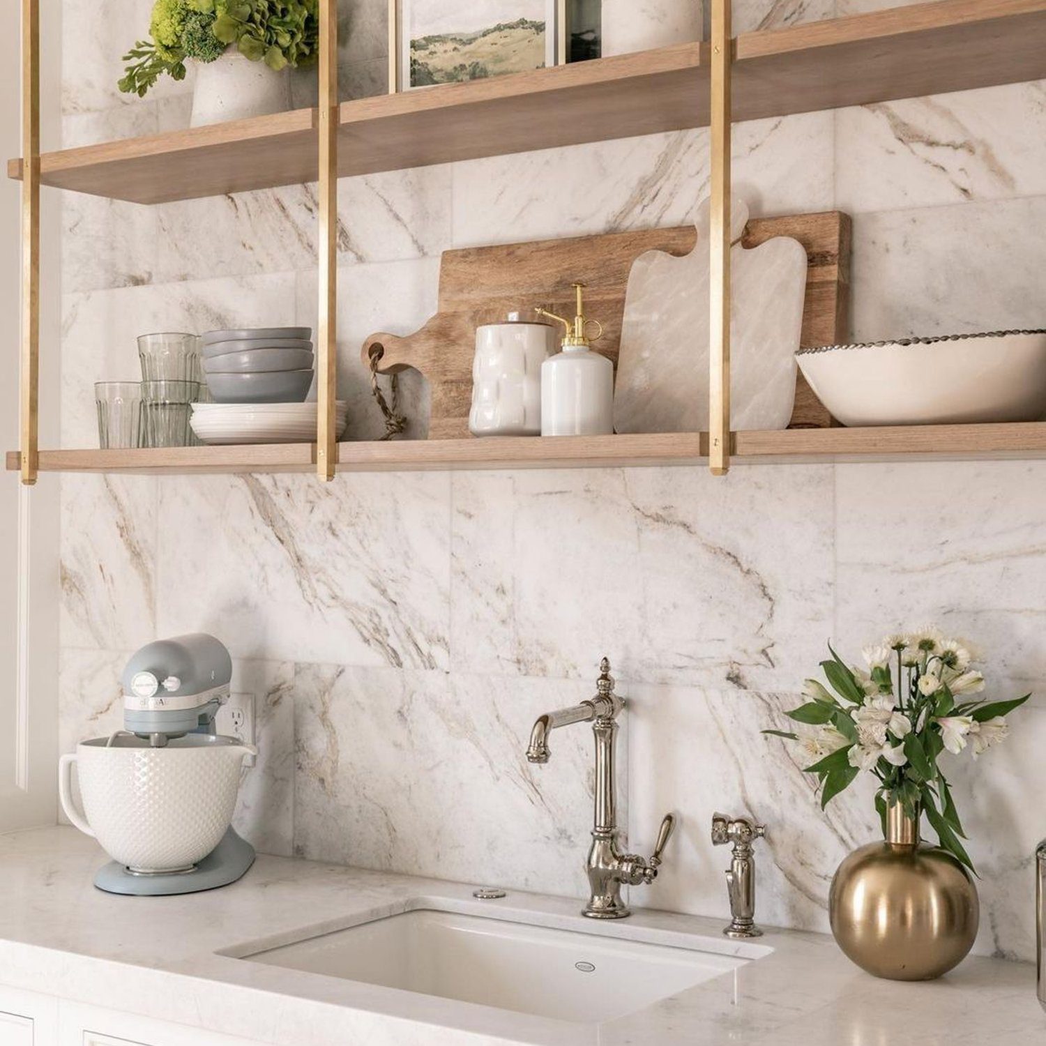 Elegant kitchen design featuring marble backsplash