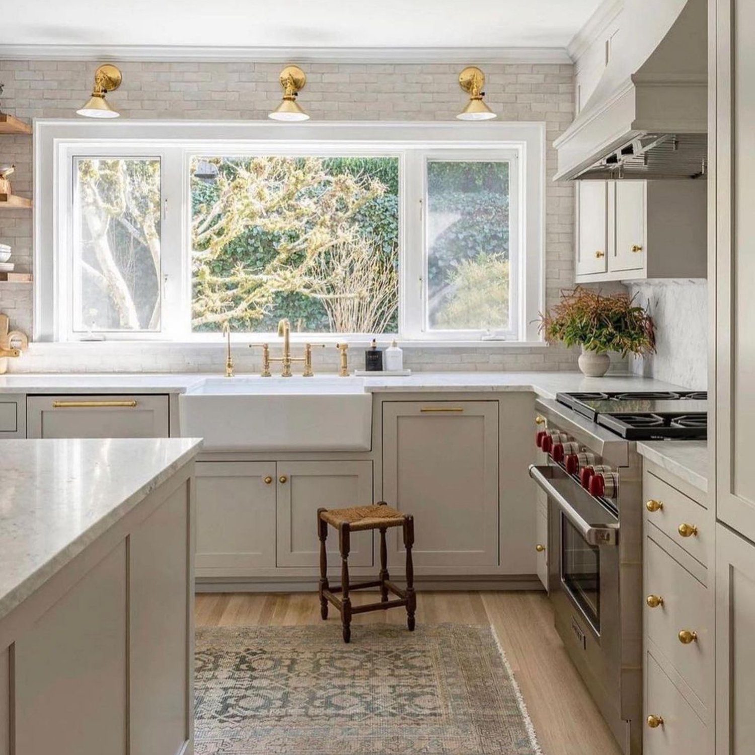 Elegant white kitchen with gold accents and natural light