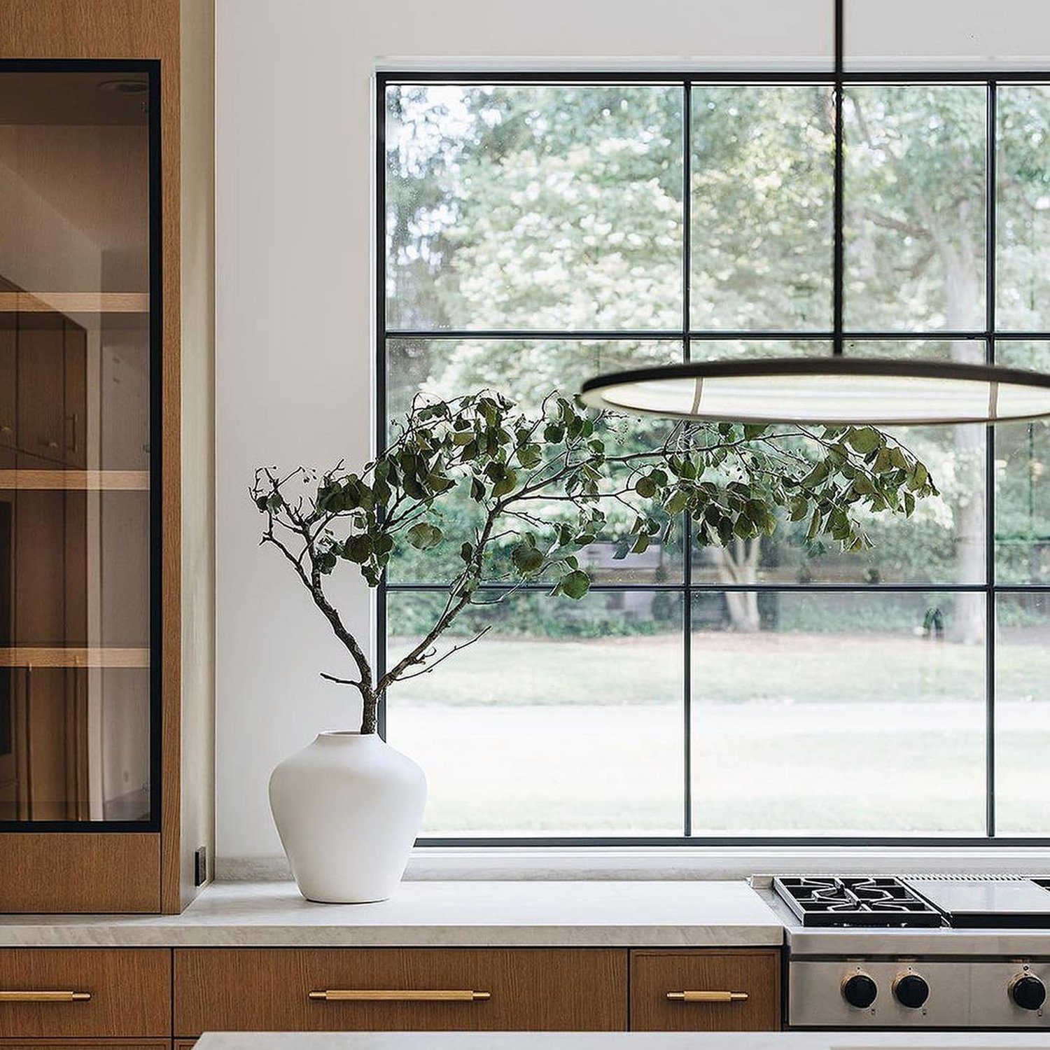 A minimalist kitchen featuring an oversized window