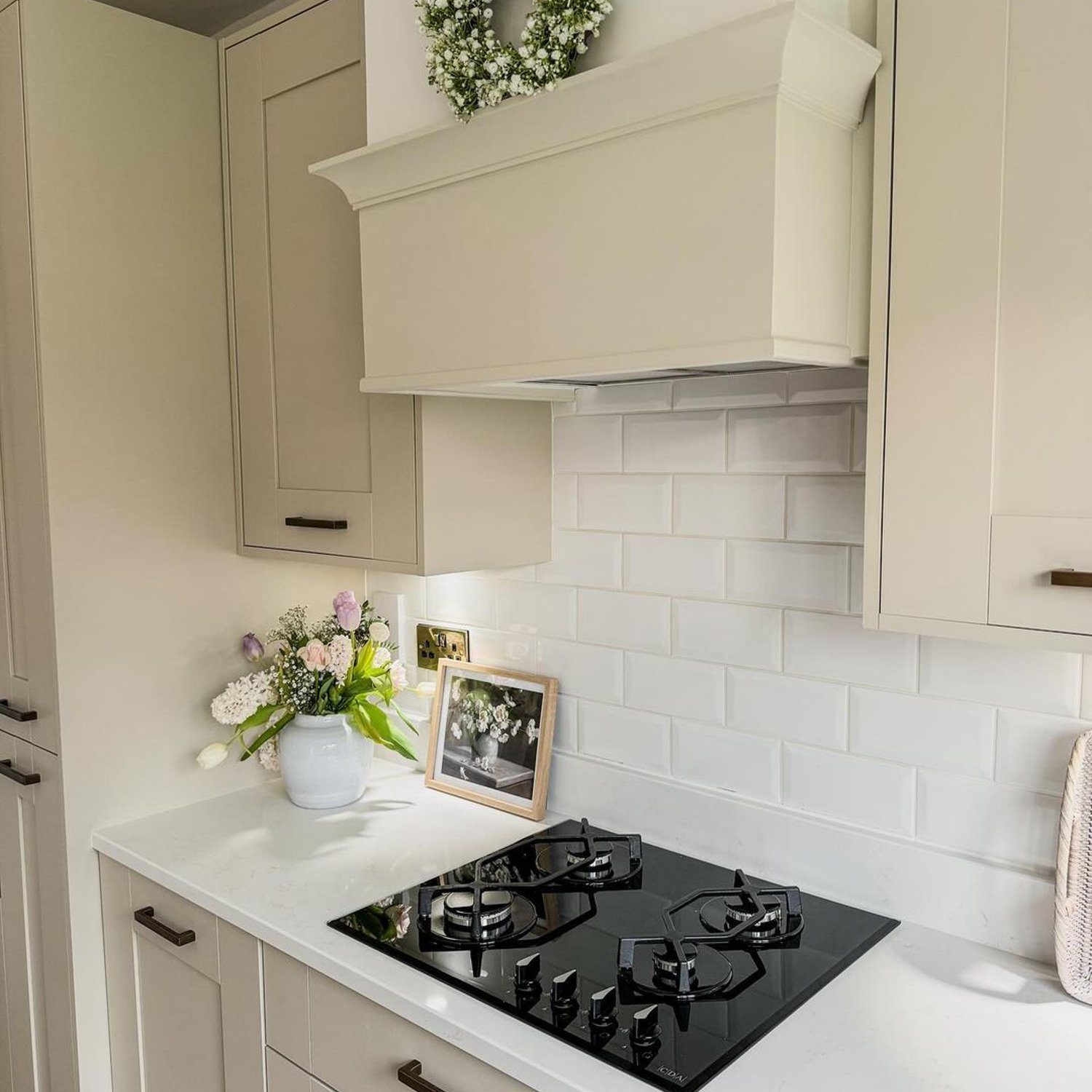 Elegant kitchen corner featuring a sleek stovetop and subtle floral accents