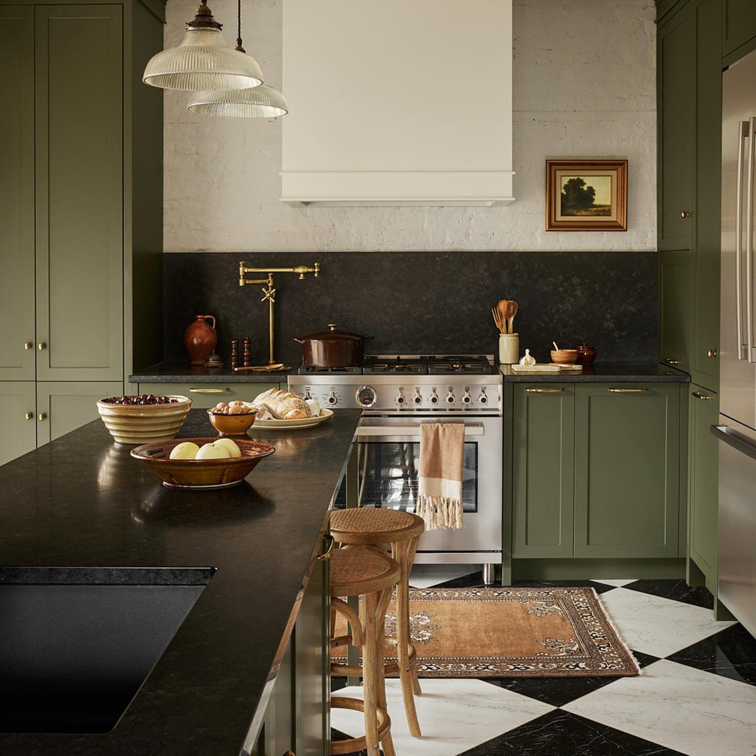 Elegant green-toned kitchen with classic design elements