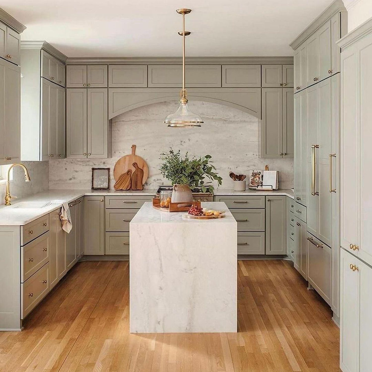 Elegant and spacious kitchen featuring a marble island centerpiece