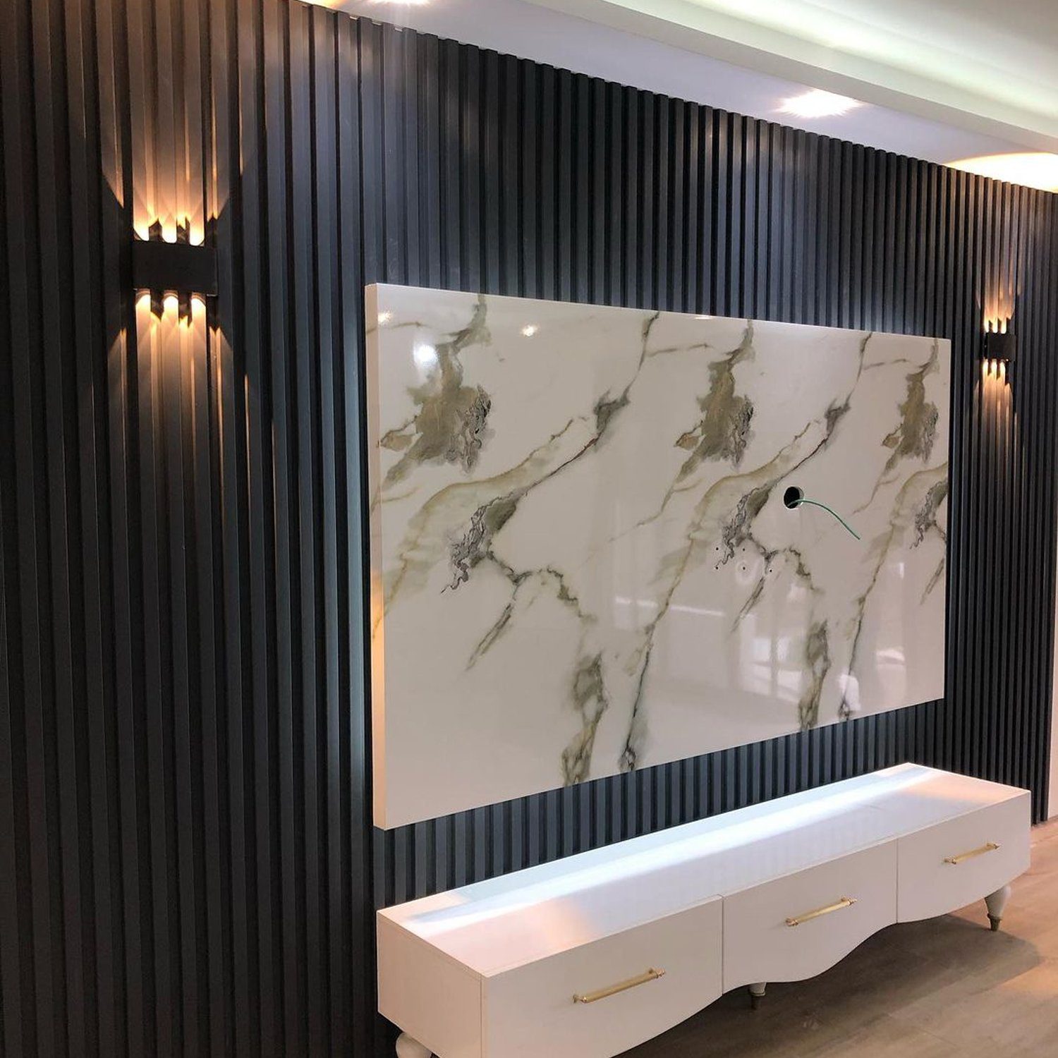 Elegant living room wall design featuring a marble patterned panel and sleek furnishings