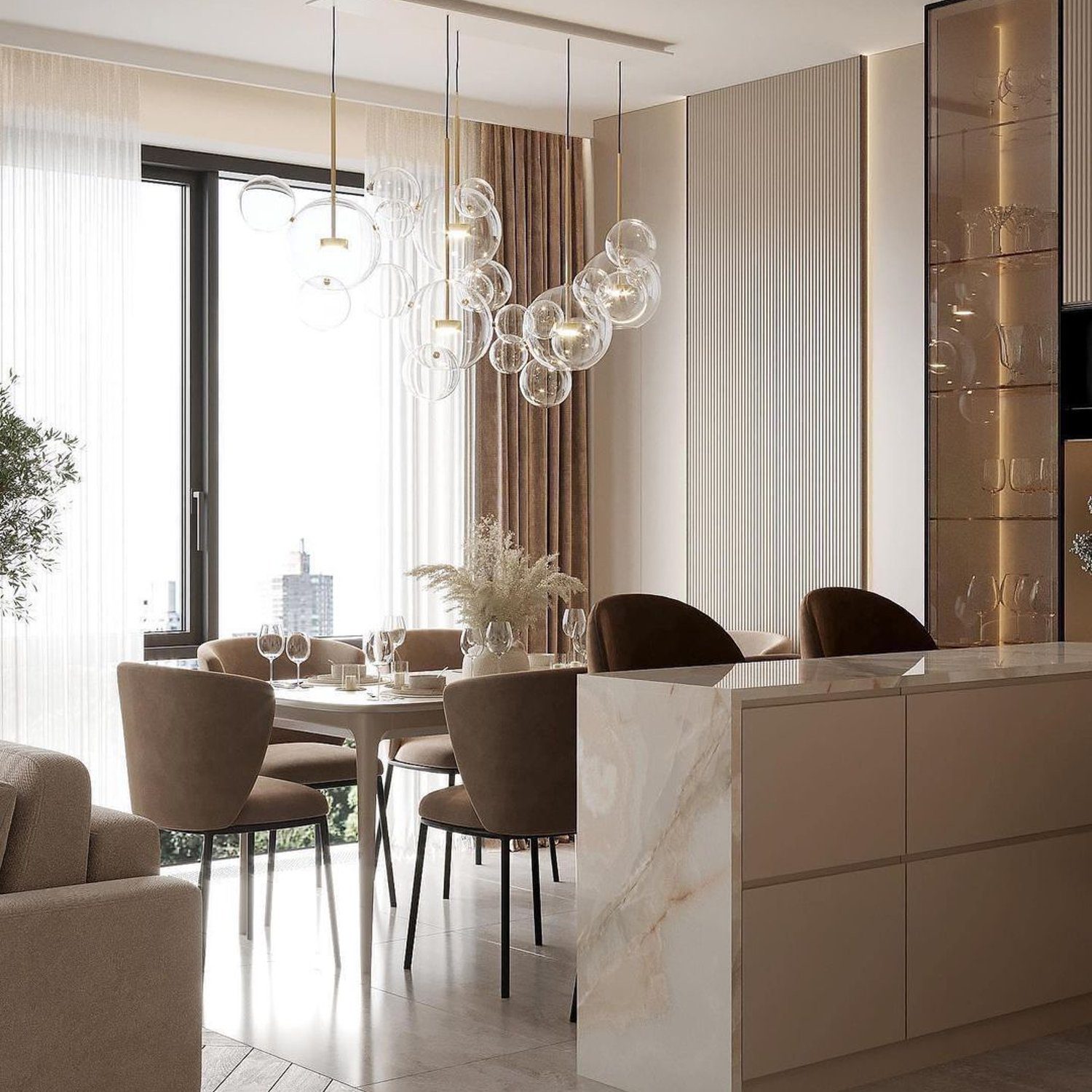 An elegant and modern dining area featuring soft velvet chairs and an artful bubble pendant light