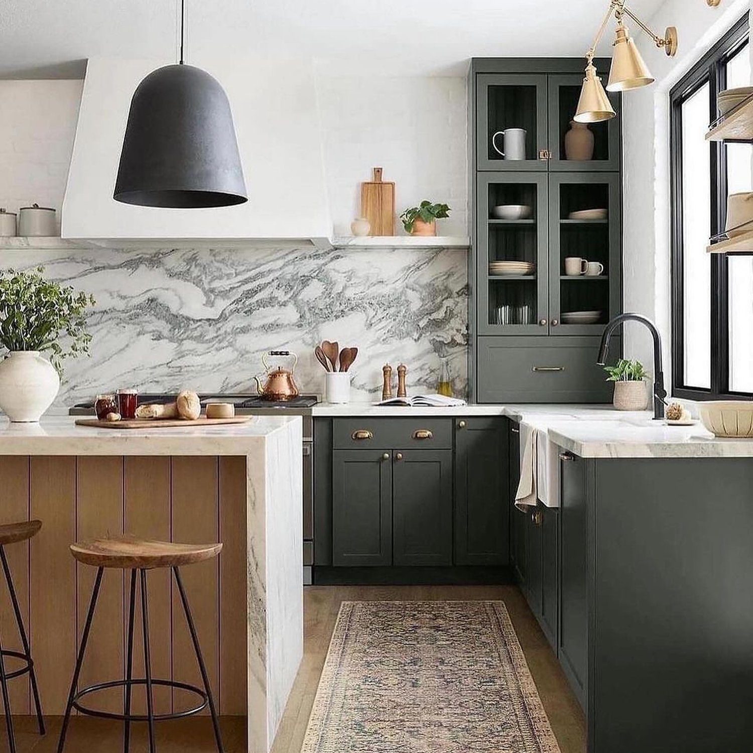 Elegant modern kitchen with marble backsplash and dark cabinetry