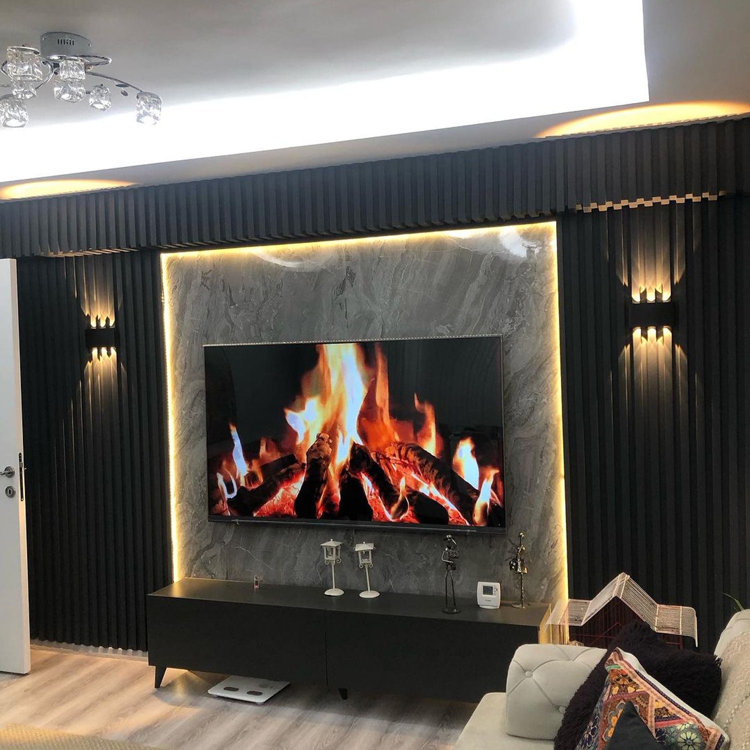 Elegant modern living room featuring a unique fireplace display on a flat-screen TV set within a marble-like wall surround