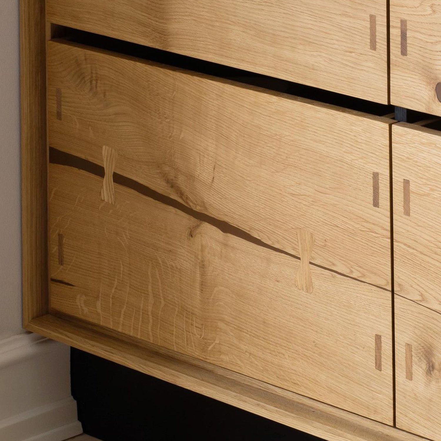 Elegant oak-wood chest of drawers with sleek cut-out handles