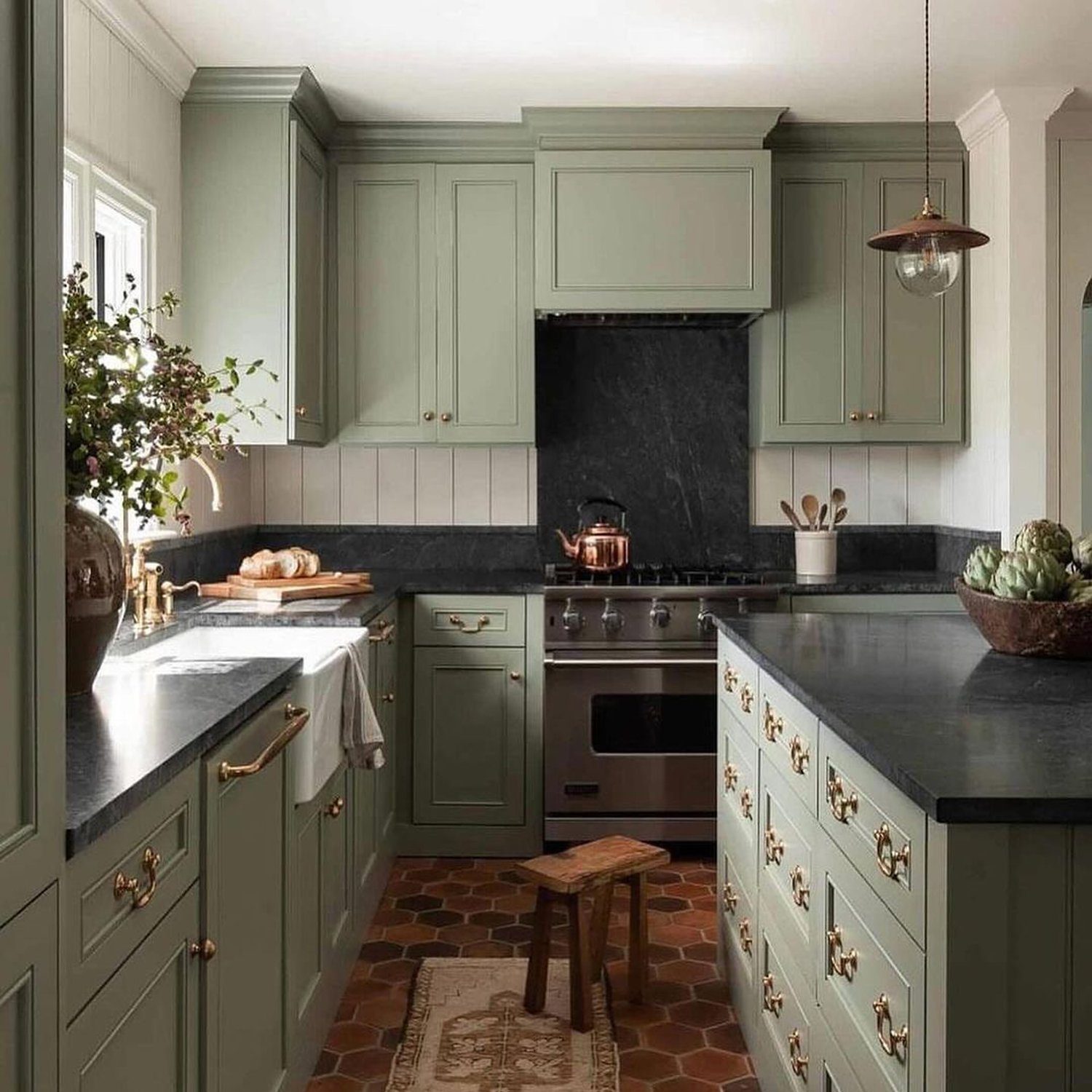 Elegant sage green kitchen with terracotta tiles