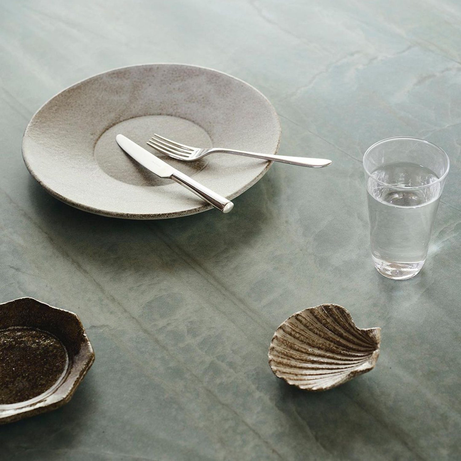 Elegant table setting with textured ceramic dishes