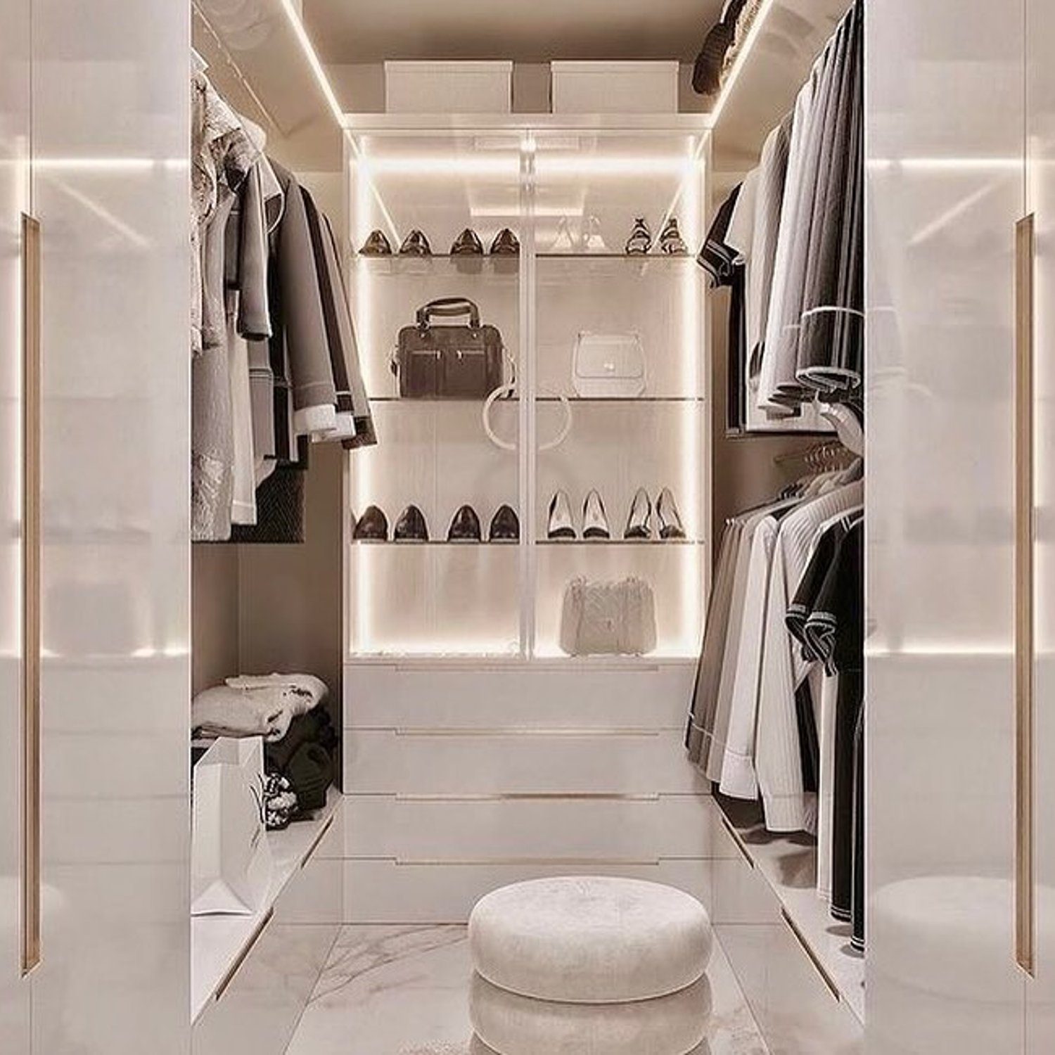 Elegant walk-in closet with accent lighting