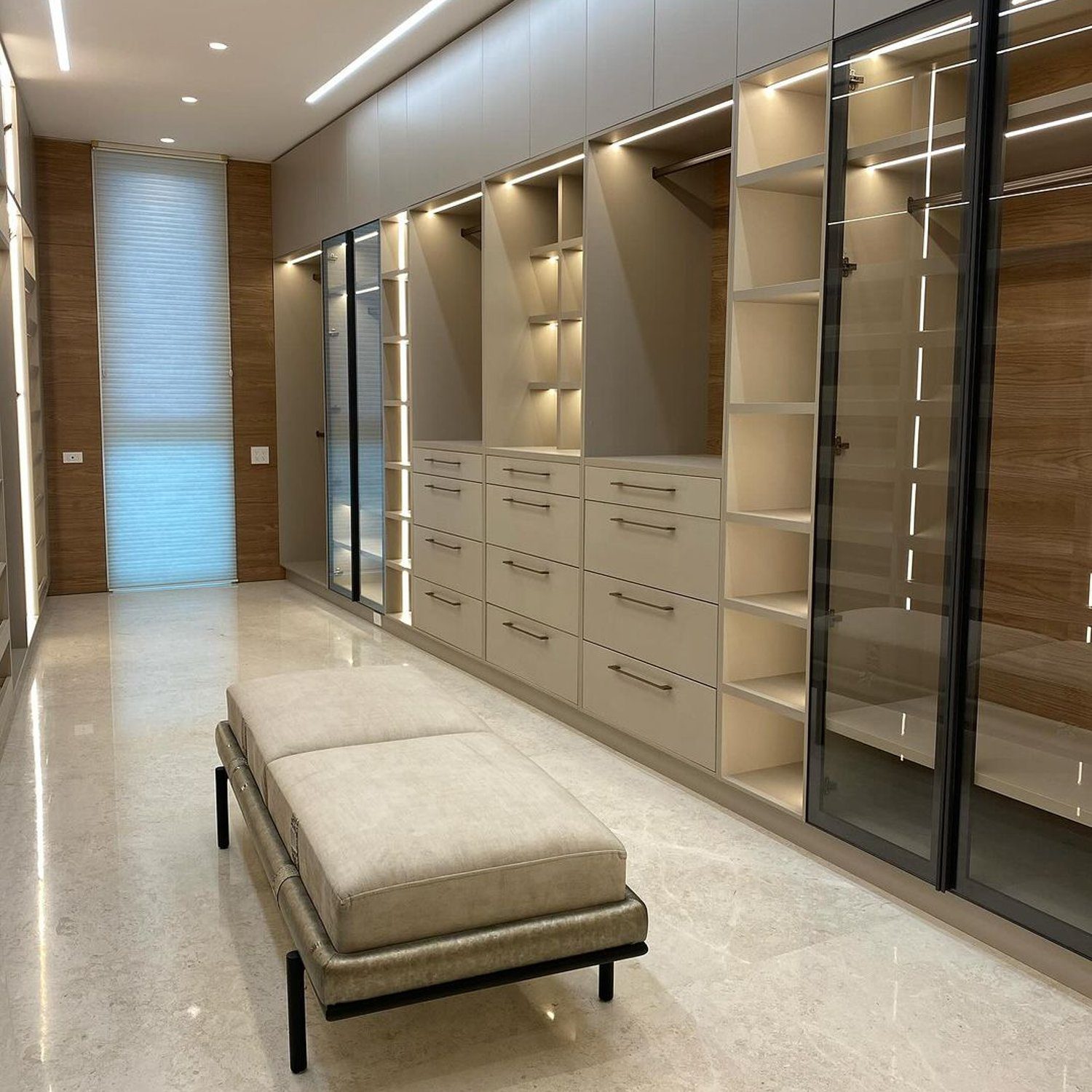 Elegant and modern walk-in closet featuring ample storage space