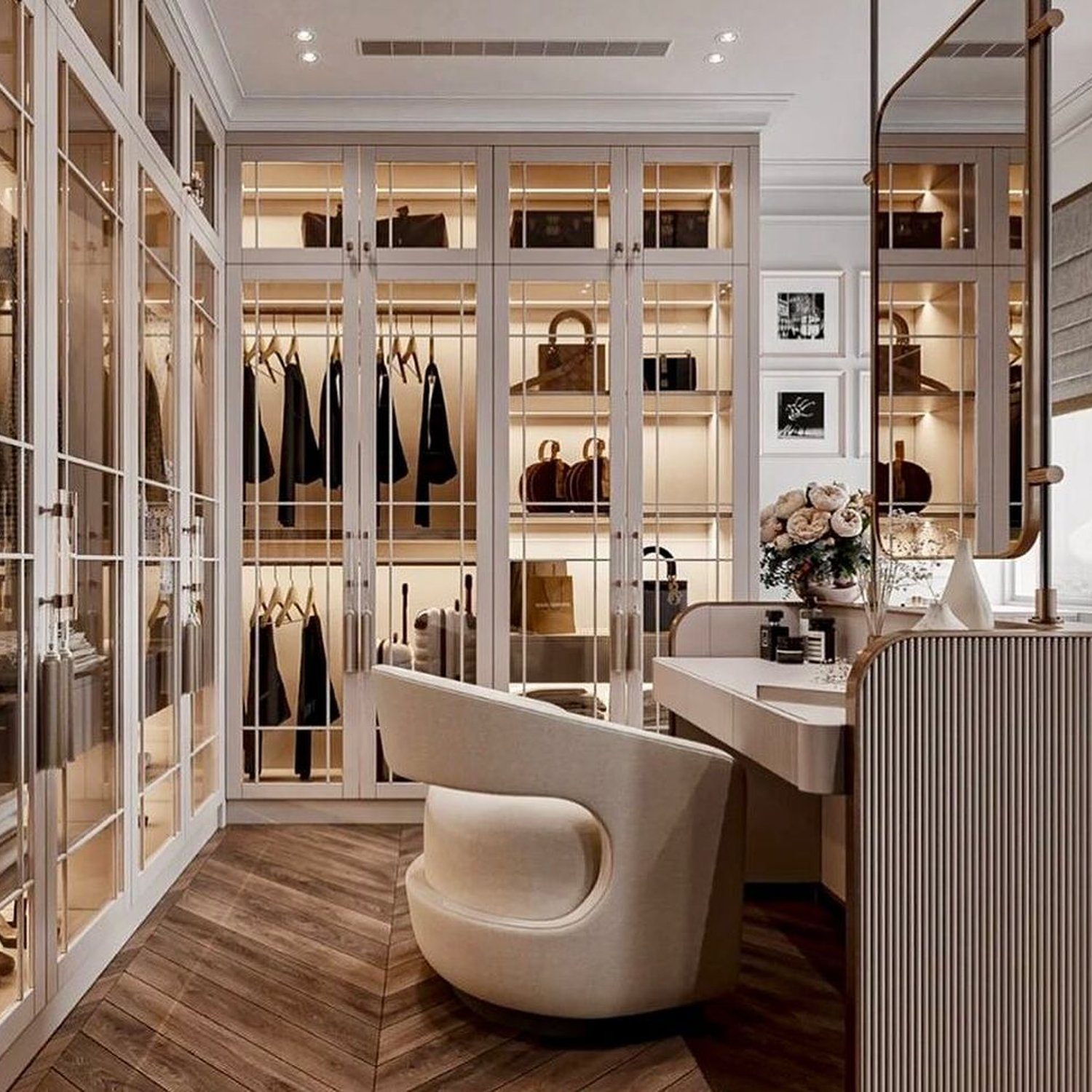 Elegant modern walk-in closet design featuring glass doors, a plush armchair, and strategic lighting.