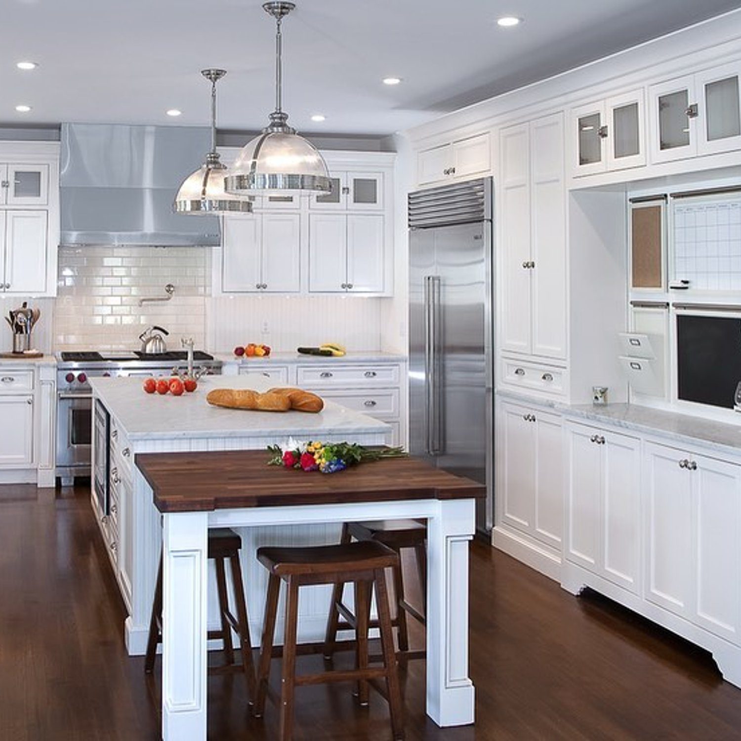 A pristine kitchen with white cabinetry and modern appliances