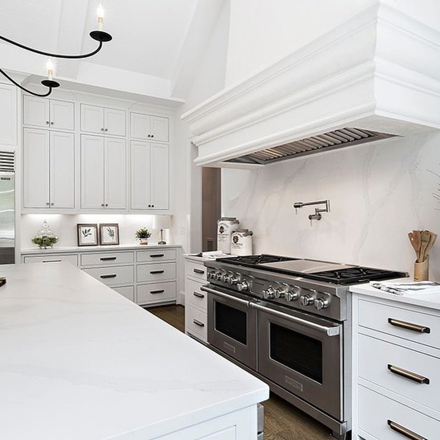 Elegant white kitchen with modern appliances and a spacious design