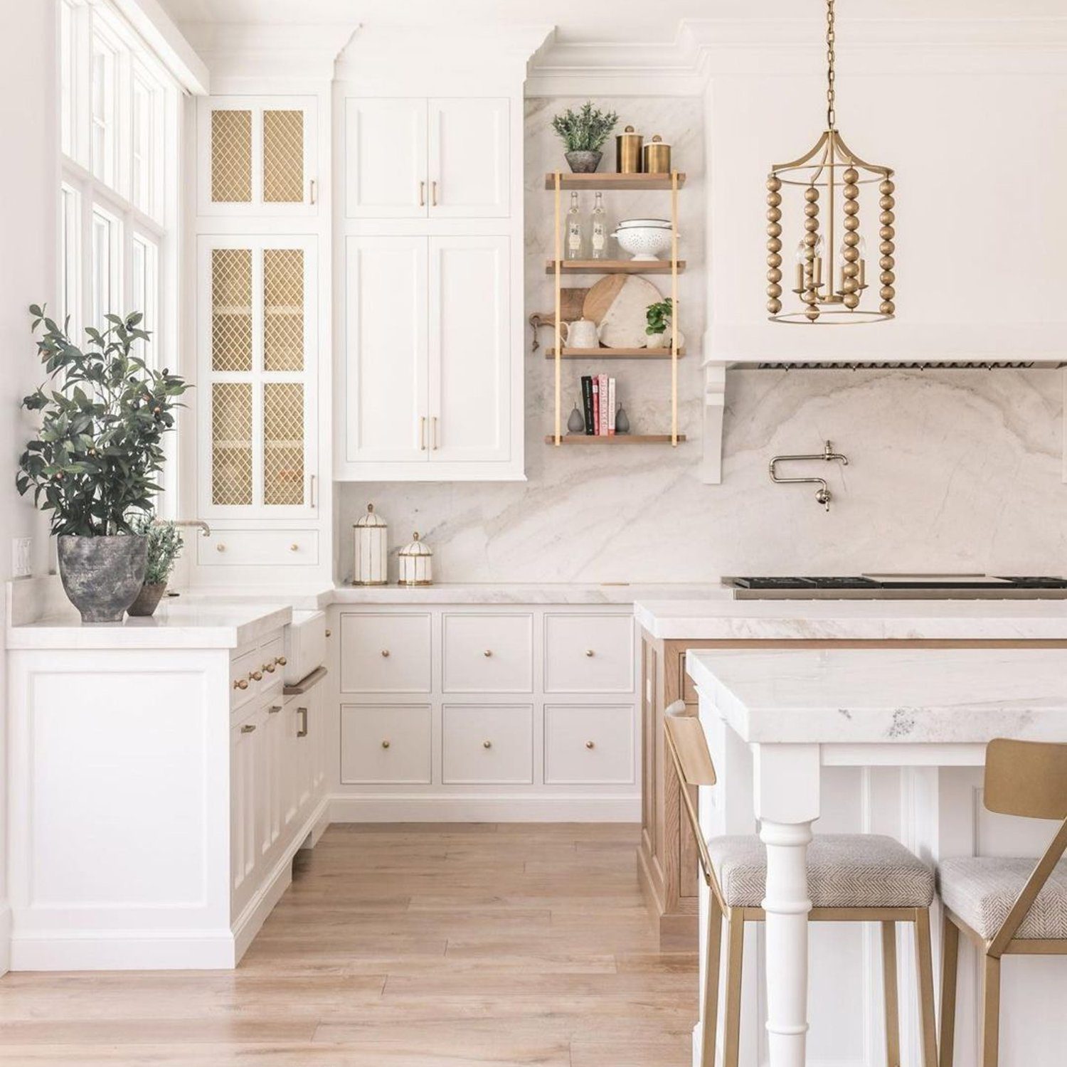 Elegant white kitchen with marble countertops