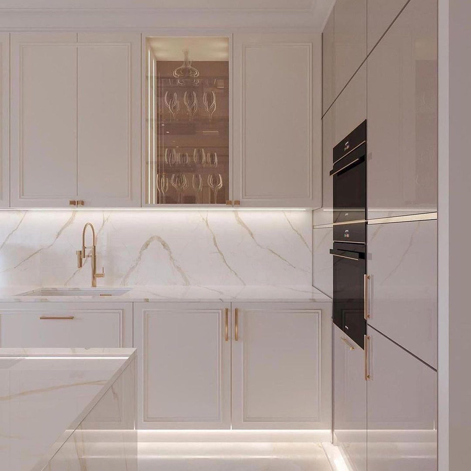 A luxurious white marble kitchen with gold accents and modern appliances