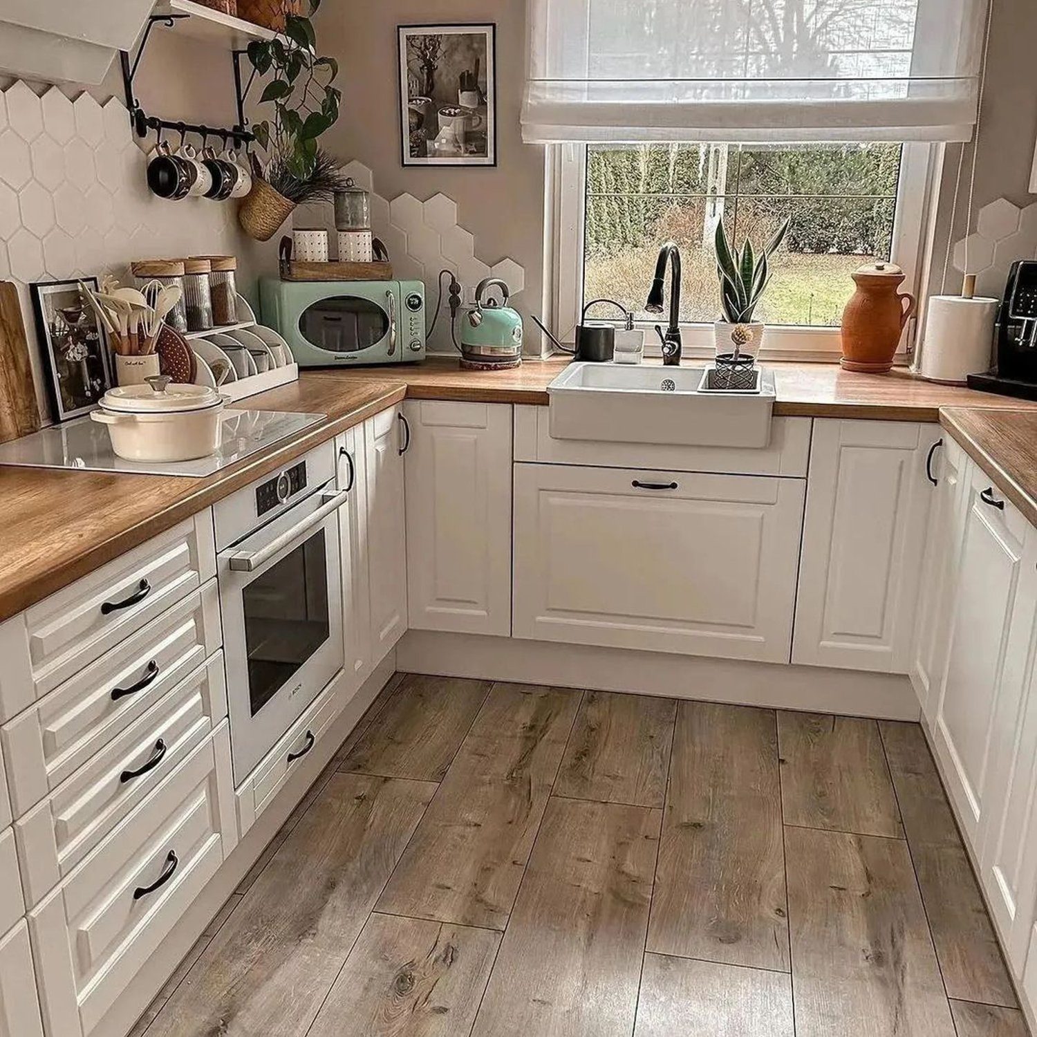 A cozy kitchen space featuring warm wooden countertops and a classic white cabinet design.