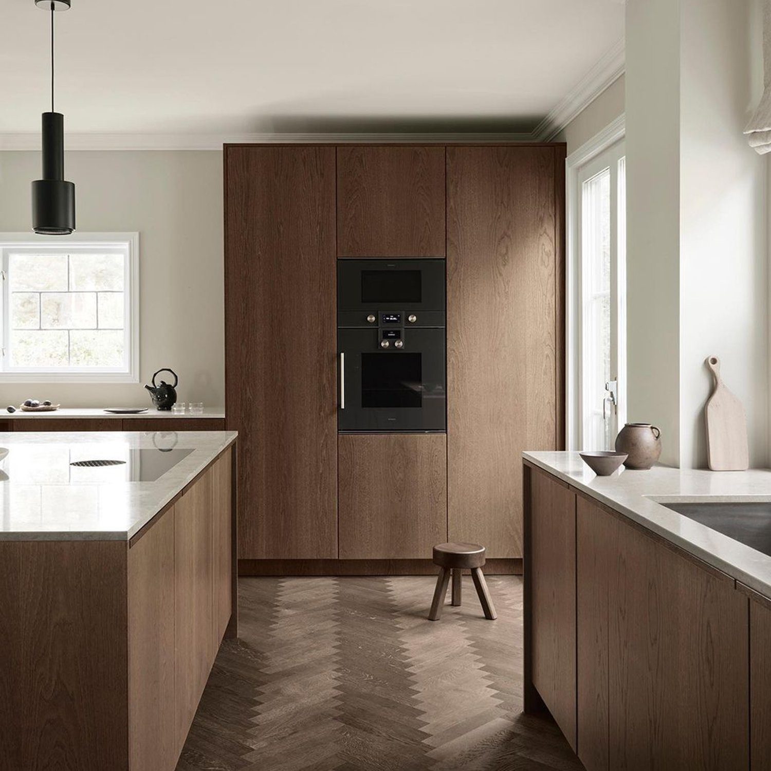 Elegant dark wood kitchen design with integrated appliances