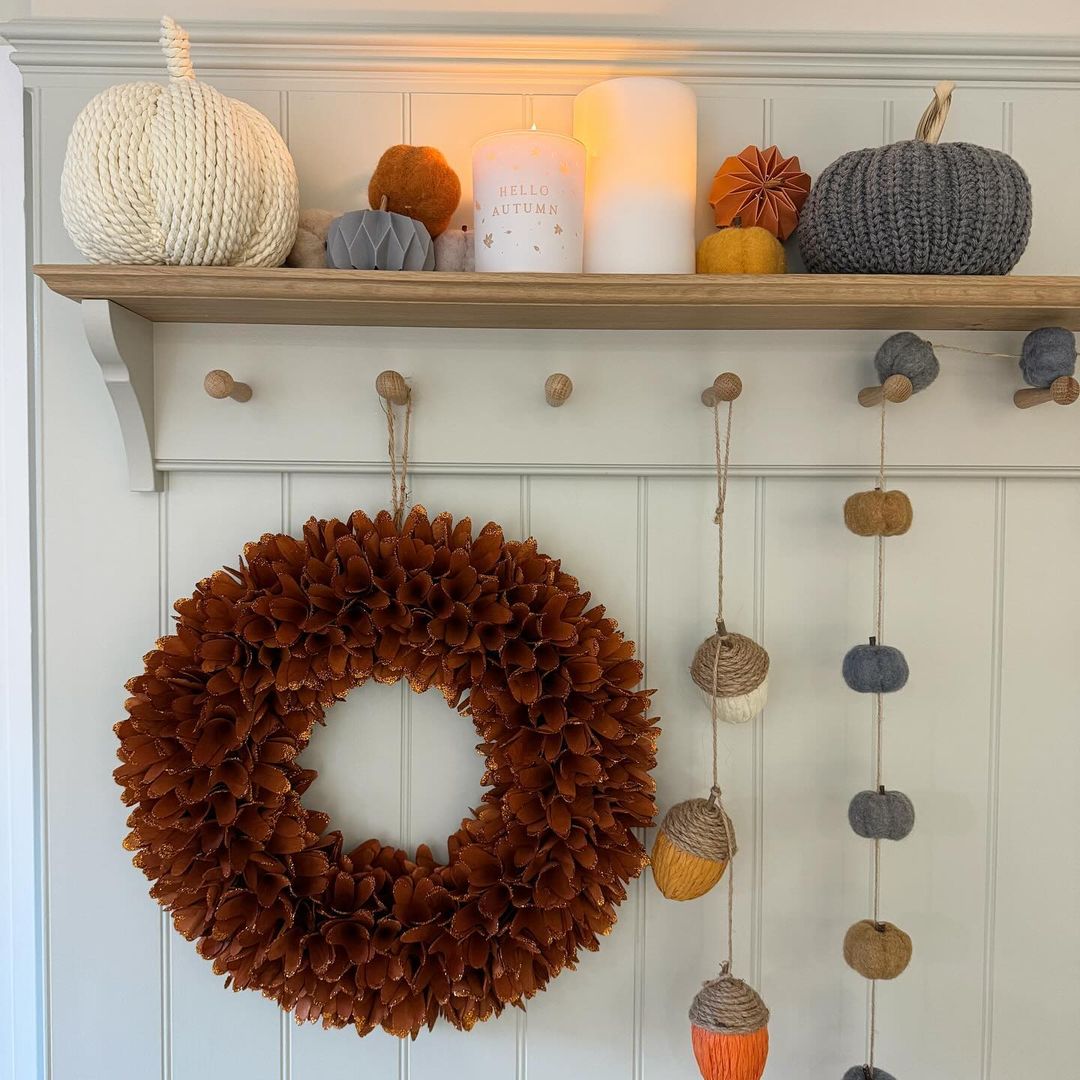 A neatly styled autumn-themed mantelpiece with decorations