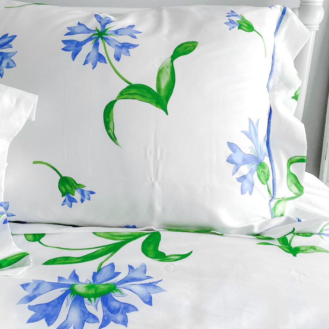 Blue and green floral pattern on white bedding